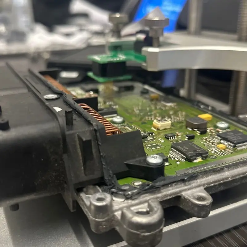 An engine control unit opened on the bench for reading